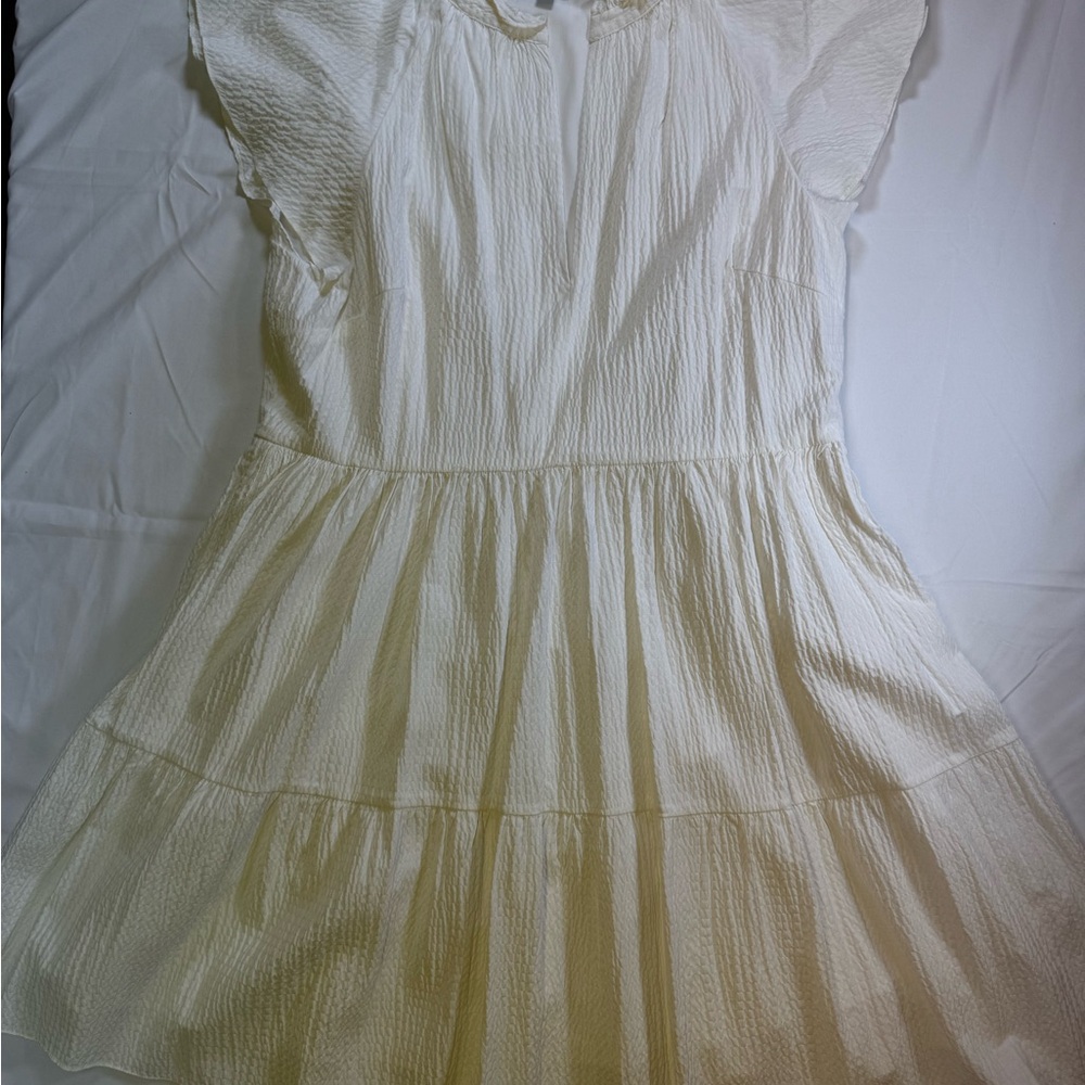 ANTONIO MELANI Women’s White Dress with capped ruffle sleeves.